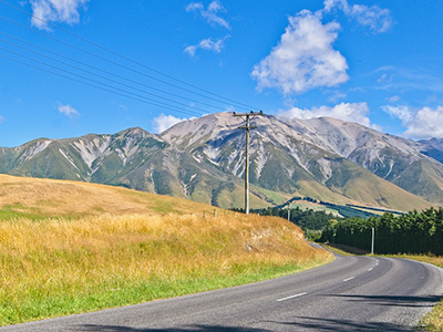 New Zealand road with mountains in background